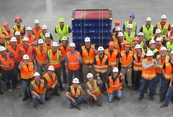 澳门足彩app employees posing with a pallet of beer.